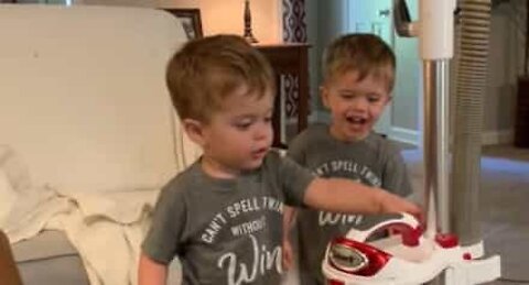 Twins suck up laughter over vacuum cleaner button