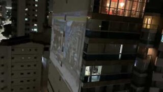 Guy projects video game onto apartment block facade while in quarantine