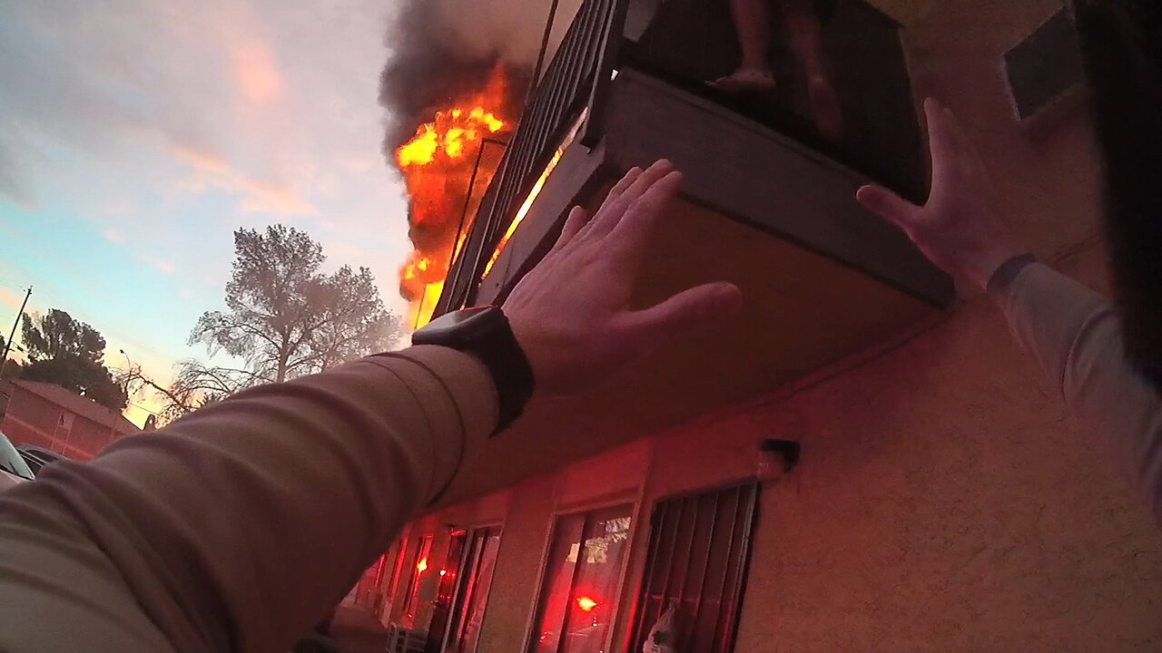 Police Officer Climbs on Dumpster to Rescue Woman Trapped on Balcony