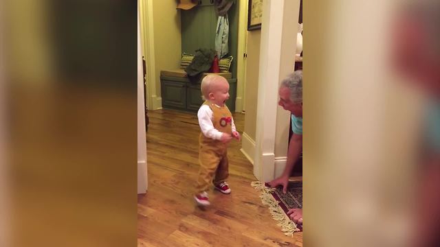 A Toddler Boy And His Grandpa Play Peek A Boo