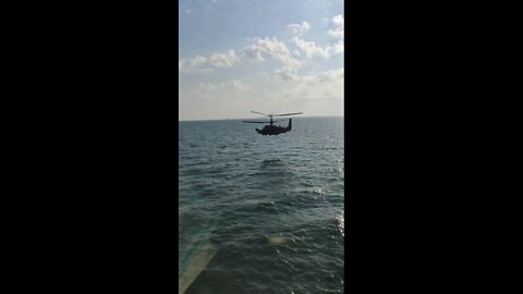 Ka-52 helicopter cruising over water