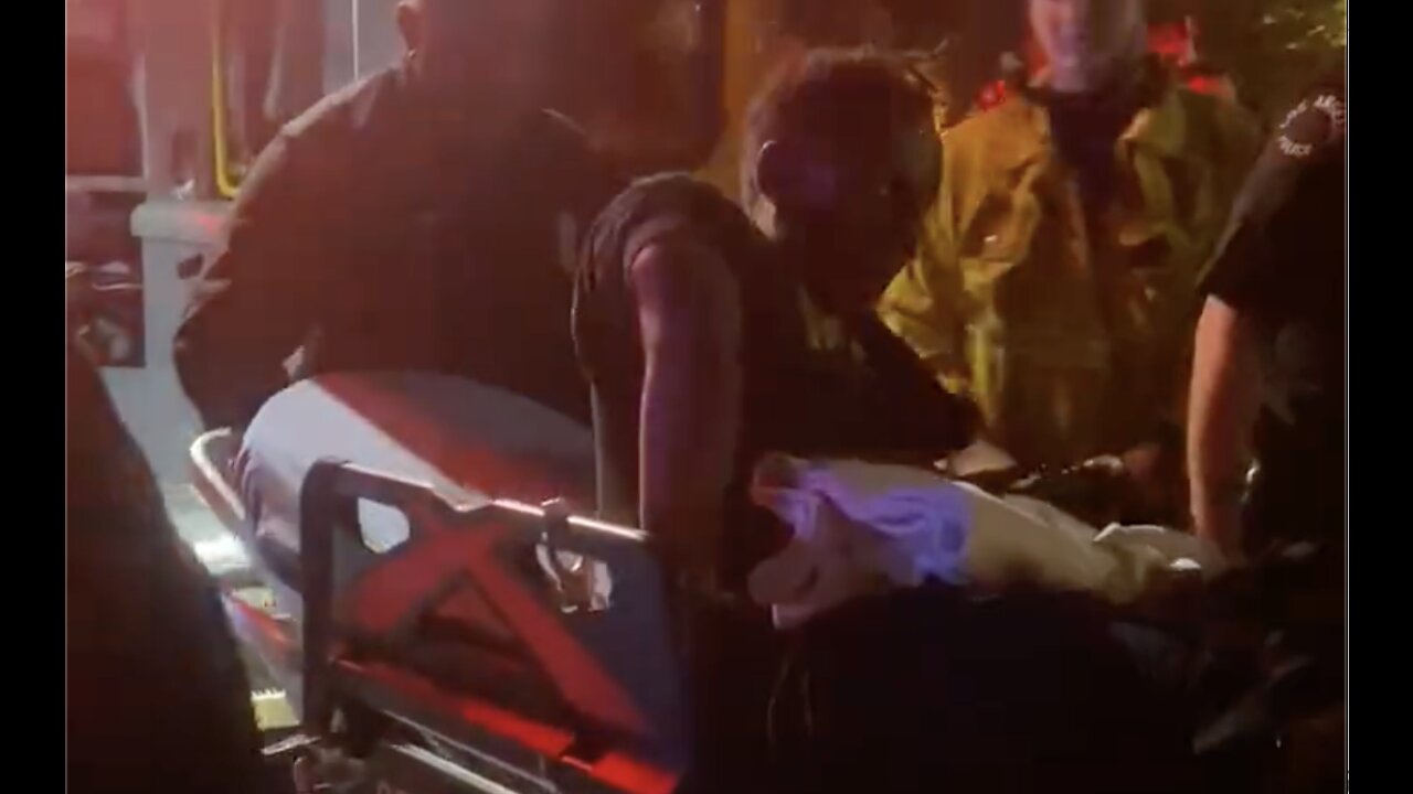 Chappelle’s Attacker Seen on Gurney with Grotesques Arm Injury