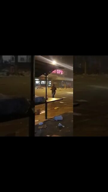 SA Riots ( woman prays in the street after the chaos )
