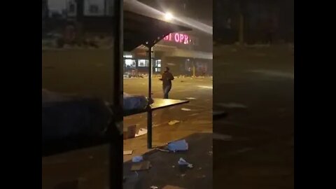 SA Riots ( woman prays in the street after the chaos )