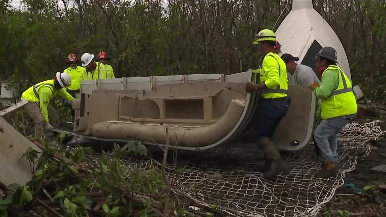Removing boats from mangroves after Hurricane Ian