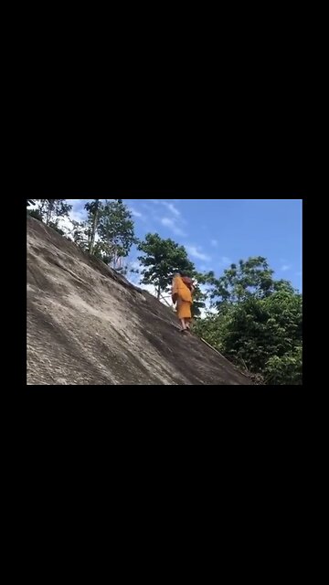 Monk Walks Up Steep Cliff With Ease