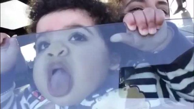 Little girl hysterically licks car window