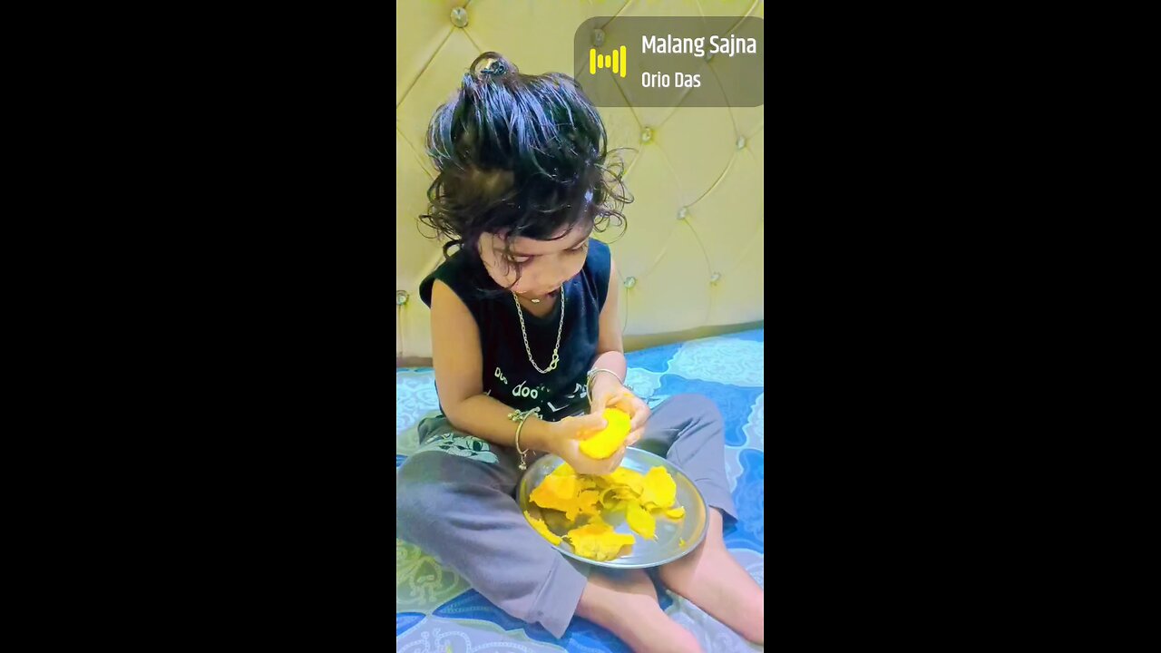 Cute girl child eating mango