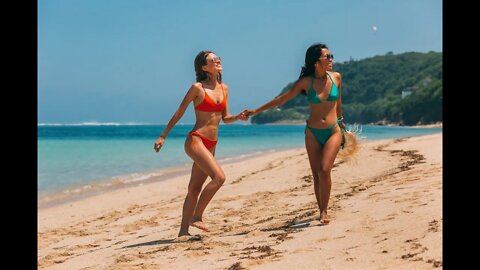 Barefoot legs of young female walking on the sunraise and sunset beach, Girl walking on beach shore.