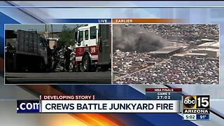 Fire crews battle first-alarm fire at a junkyard in Phoenix