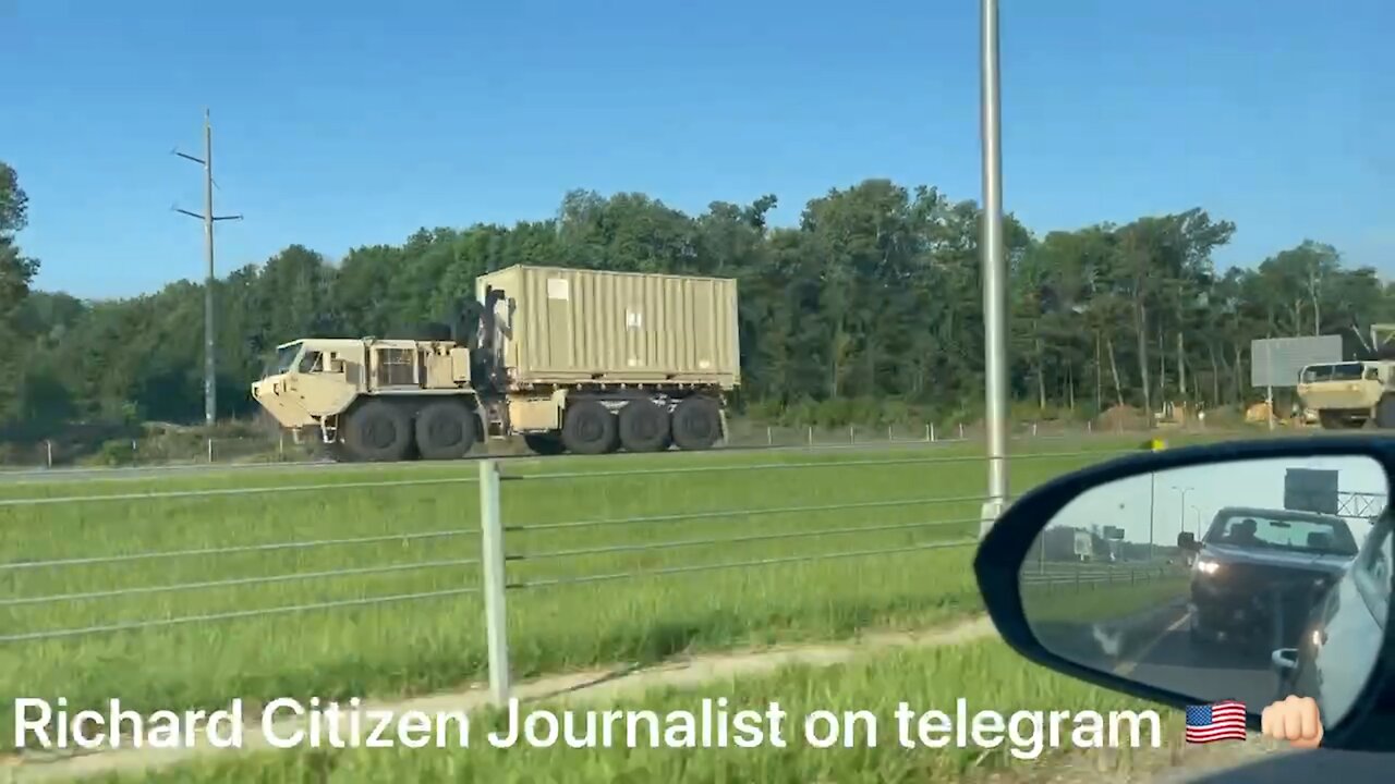 Journalist Films a Convoy of Trucks Hauling Military Equipment - 2525