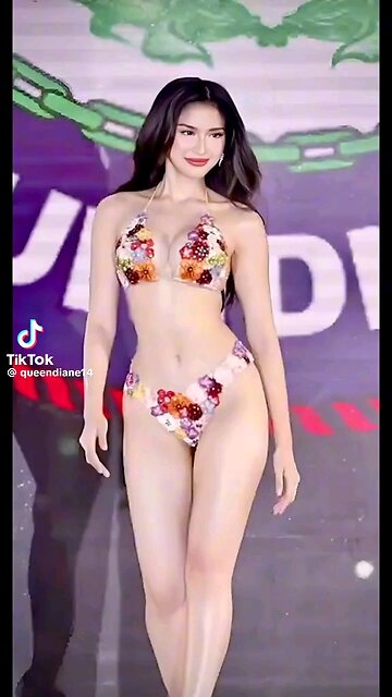 Radiant Filipina Queen Shines on Stage with a Bright Smile.