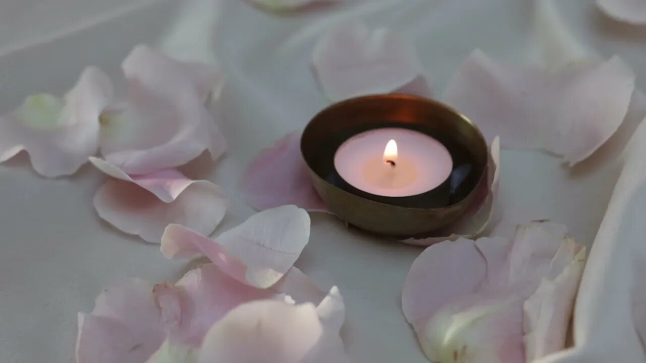 soothing candle surrounded by petals