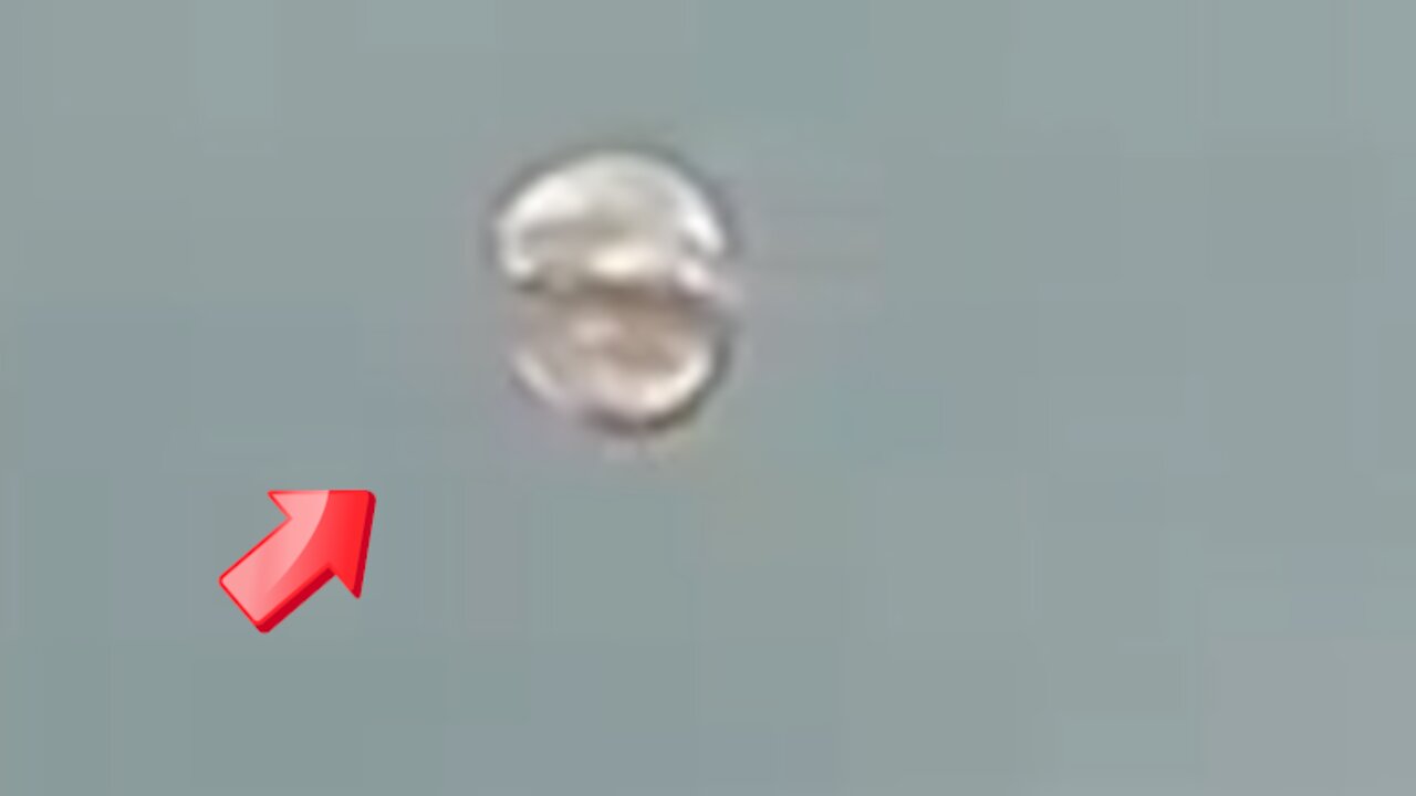 Spherical UFO seen in the sky above[Space]