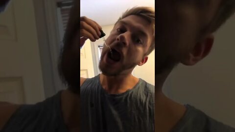 Taking a dropper of vitamins
