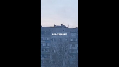 A Ukrainian sniper on the roof of a residential building
