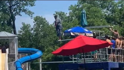 Nervous swimmer takes the plunge after pool crowd encouragement