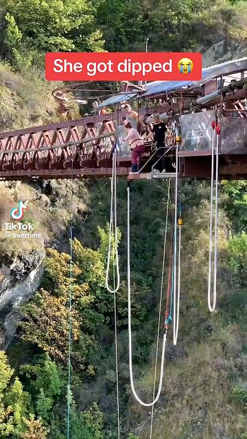The splashing Adventure"girl playfully dipping into the crystal-clear water of a serene lake.