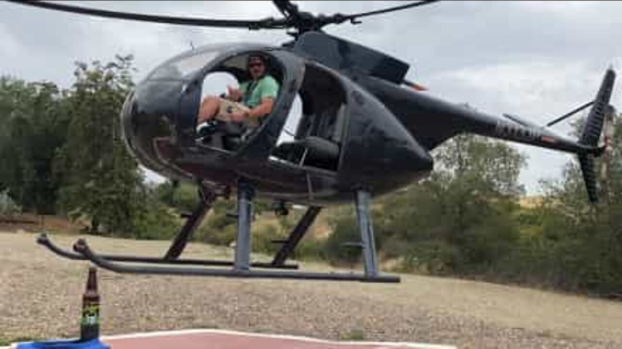 Pilot opens beer bottle with a helicopter