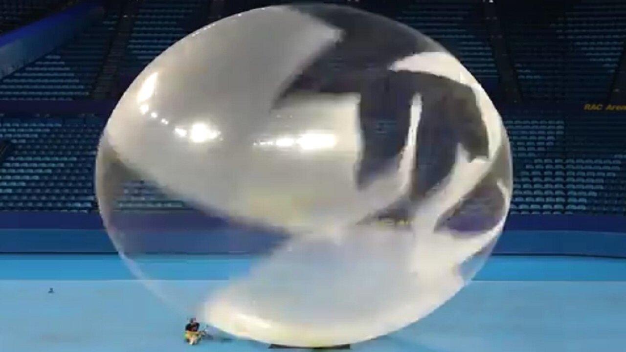 A HUGE burst of a HUGE balloon in slow motion
