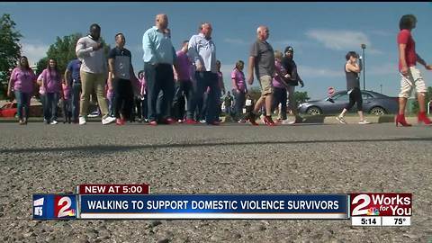 Men wear red high heels in walk to support domestic violence