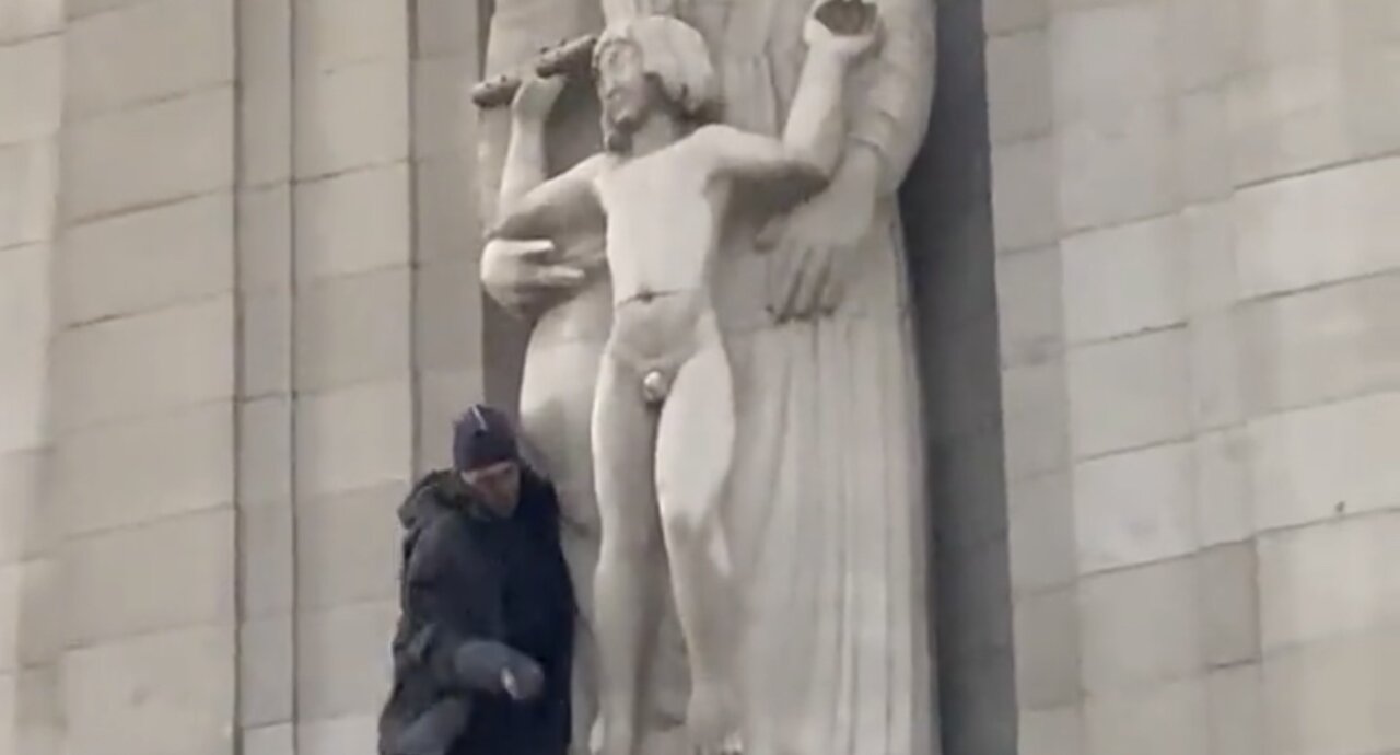 Someone has climbed onto the BBC building and smashing up the Eric Gill pedo statue