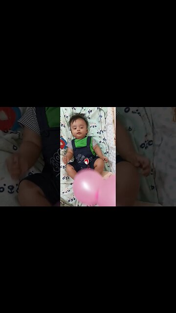 4 months old baby playing with balloon