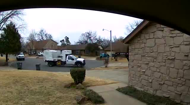 Surveillance video: Trash truck passes by full bins