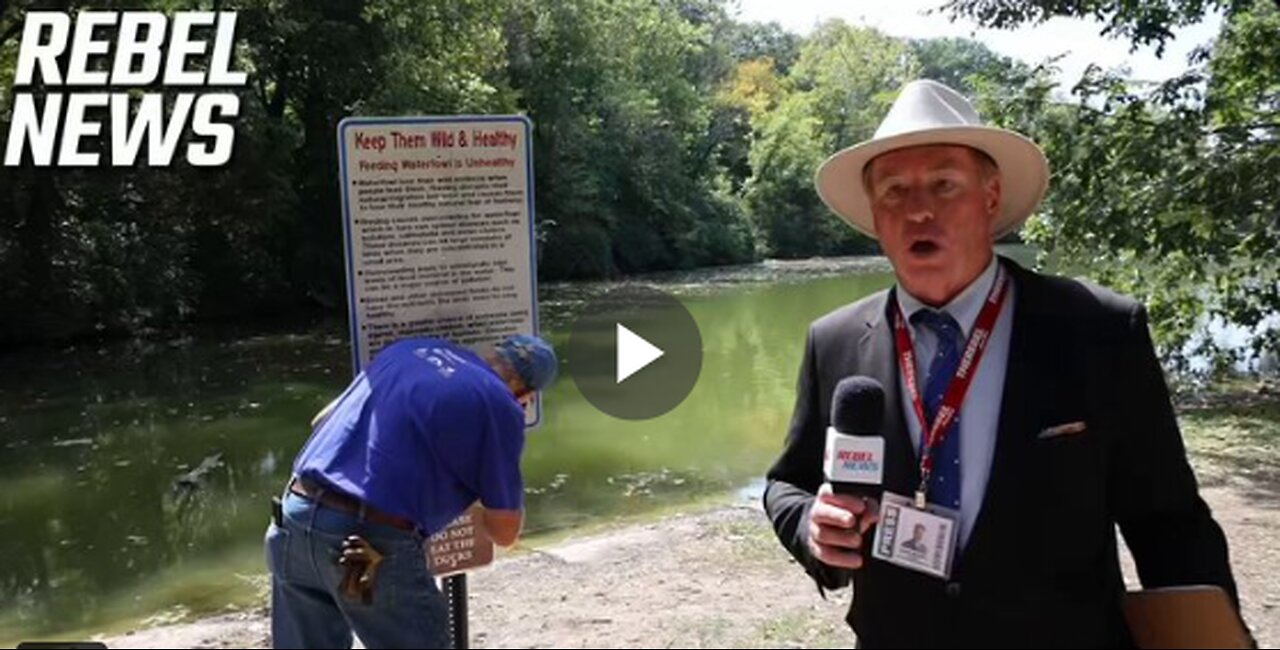 A resident of Springfield, Ohio shows off sign in Snyder Park that states PLEASE DO NOT EAT THE DUCK