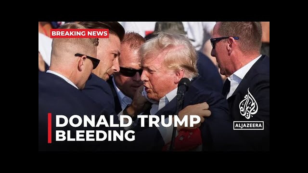 Former President Donald Trump bleeding after what sounded like gunshots