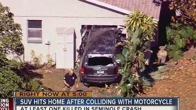 SUV hits home after crashing with motorcycle