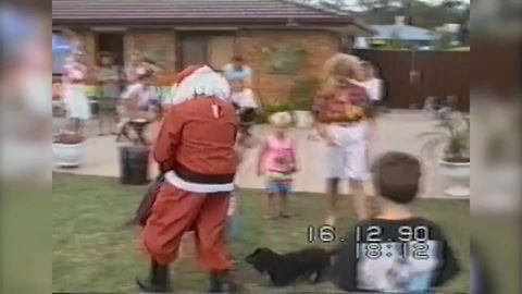 "Small Black Dog Barks Madly At Santa And Chases Him Around Yard"