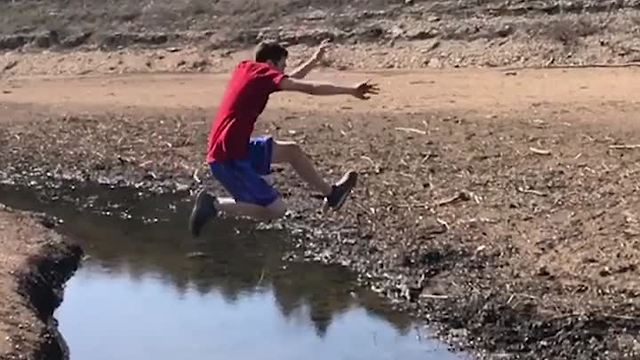 Boy Makes Huge Jump Across Stream, Will He Make It?