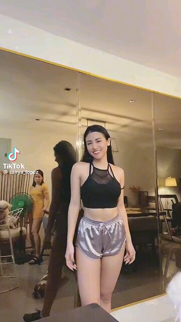 "Swaying Elegance: A Filipina's Dance in the Sun" Visual Description (VD): A stunning Filipina woman