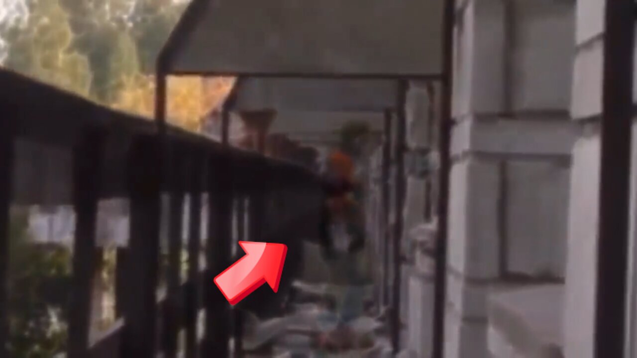 person dressed in orange is standing on the balcony of an abandoned facility [Ghost]