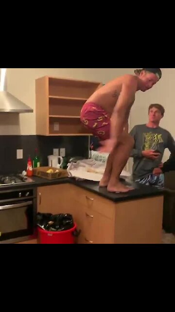 Dude does front-flip onto kitchen floor, acts like it's no big deal