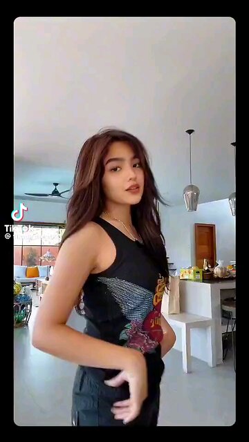 "Swaying Elegance: A Filipina's Dance in the Sun" Visual Description (VD): A stunning Filipina woman