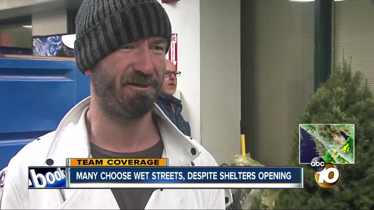 Many choose wet streets, despite shelters opening
