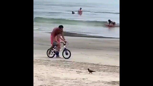 kid learning to ride his bike for first time