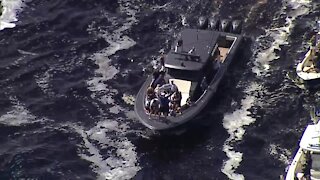 Lightning player drinks from Stanley Cup before lifting it on boat