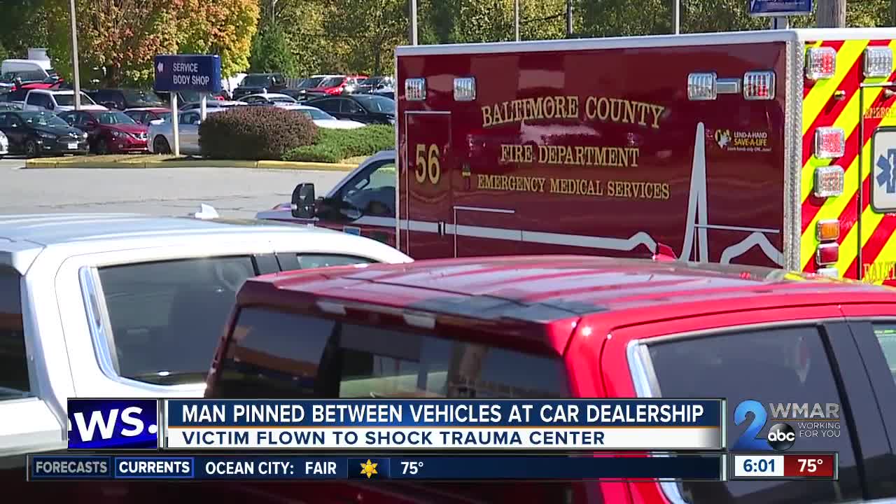 Man pinned between at car dealership