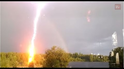 Powerful lightning strike after the rainbow, Blaiken Storuman, Sweden.