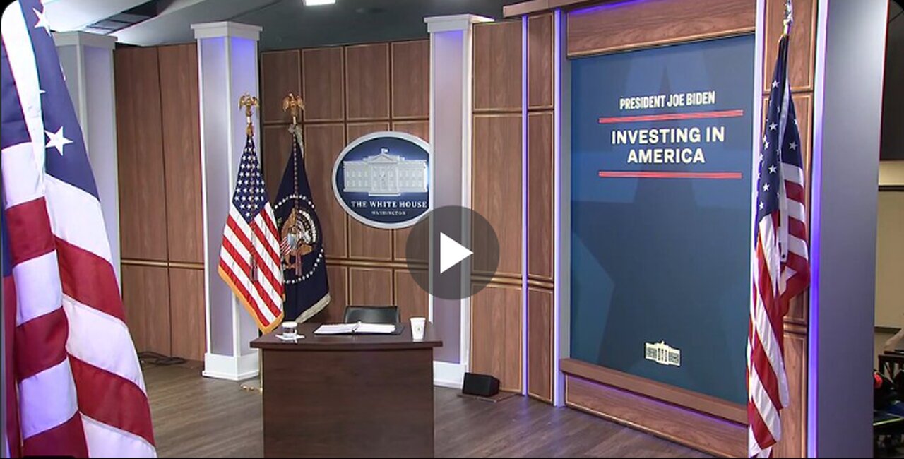 Why is Joe Biden sitting at a child’s desk?