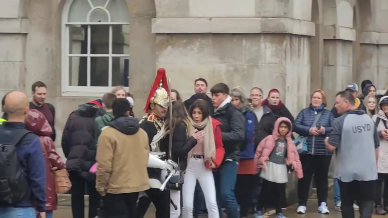 Guard pushes female tourist out of the way. make way for The kings life Guard (slow motion)