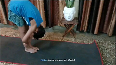 my son doing hastpadasana yoga