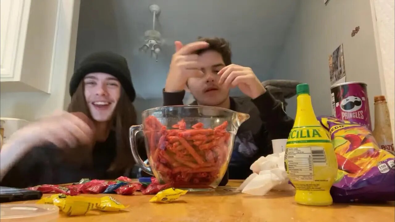 Try not to Laugh While Eating Warheads and Takis Challenge