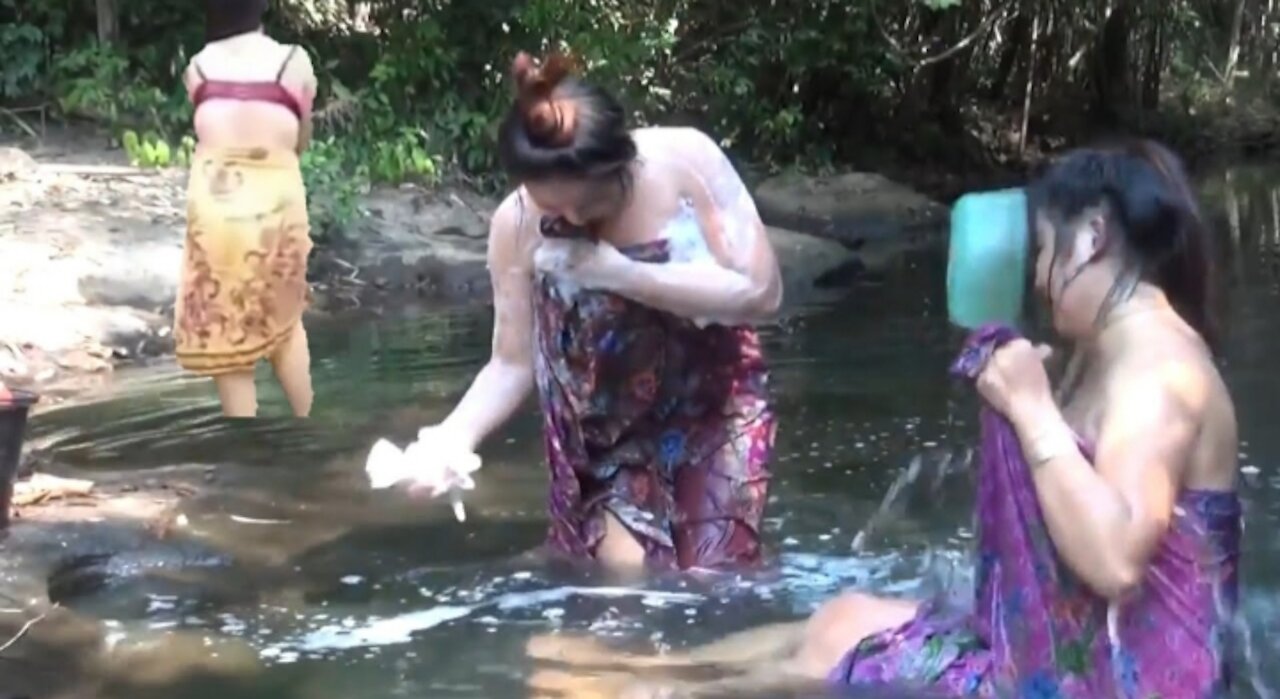 mother and daughter bathing in the river