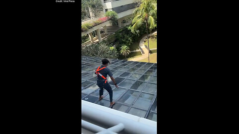 Hotel Employee Bravely Retrieves Guest's Cell Phone From Glass Roof