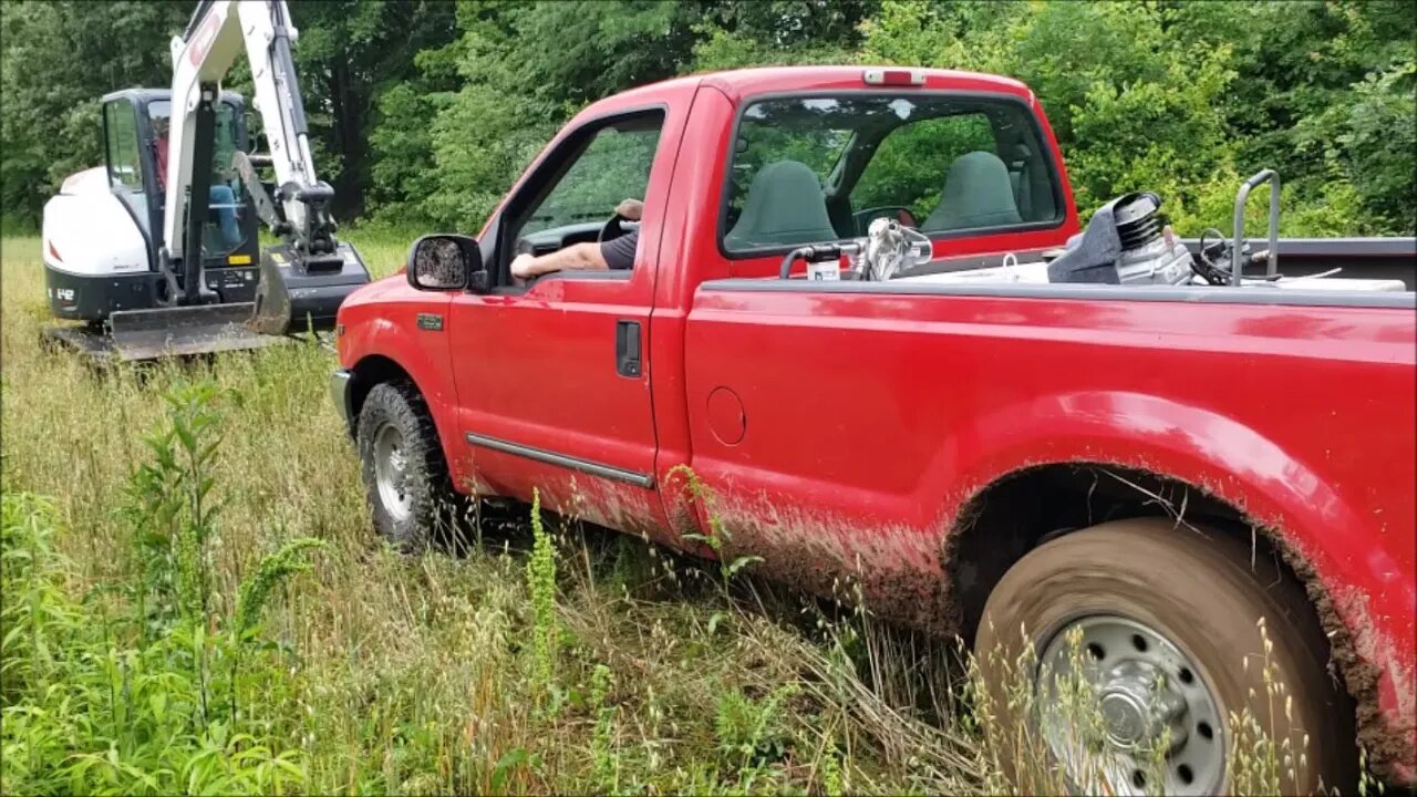 Rescue mission Ford Truck/trailer/tractor stuck in mud Bobcat e42 on the way.