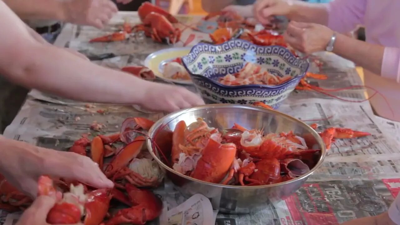 family preparing fresh lobster at dinner time